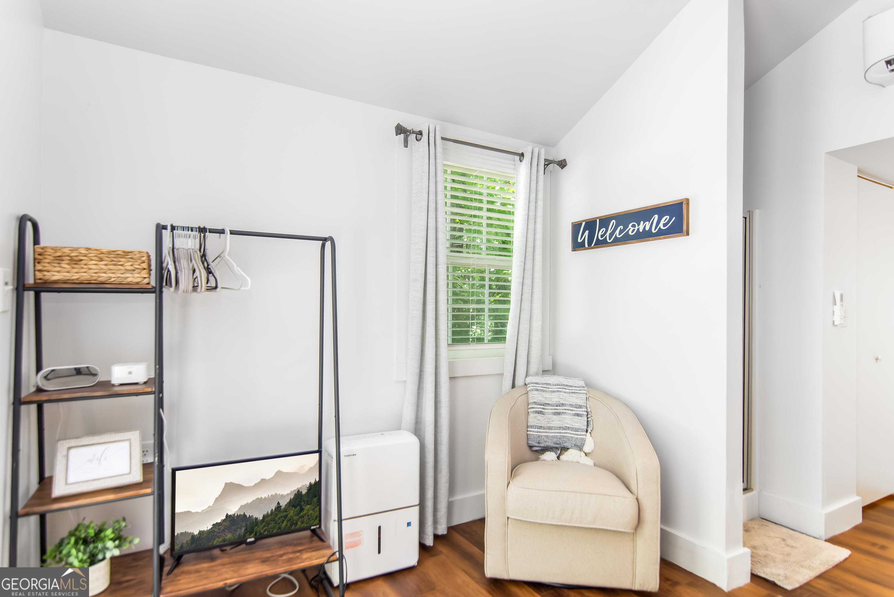 1056 Sky Hawk Mountain Road Hiawassee, GA 30546 - Photo 39 of 50 a hallway with a couch and chandelier