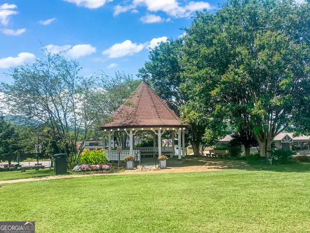 a backyard of a house with yard and outdoor seating