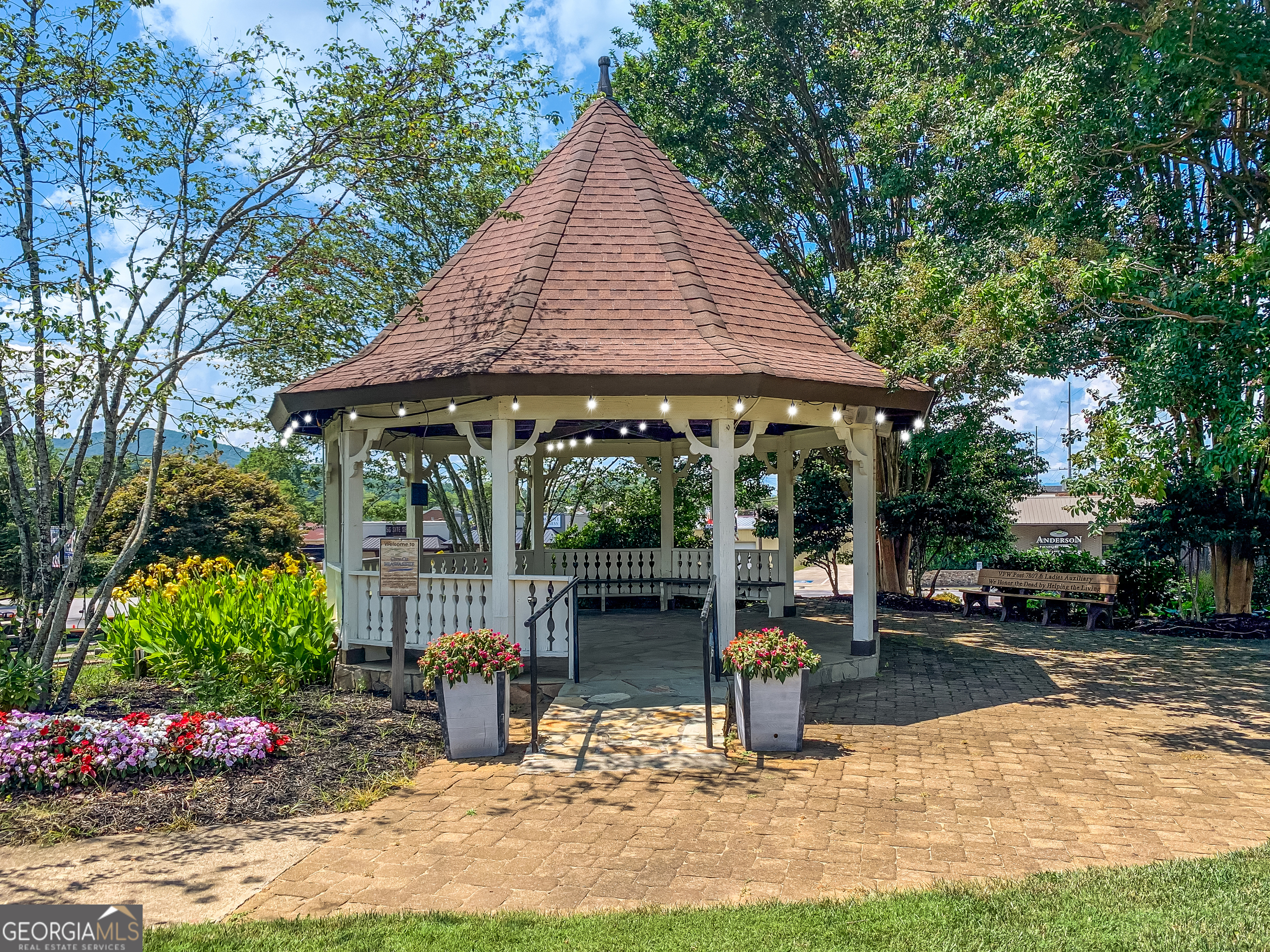 1056 Sky Hawk Mountain Road Hiawassee, GA 30546 - Photo 49 of 50 a view of a patio with table and chairs potted plants and large tree