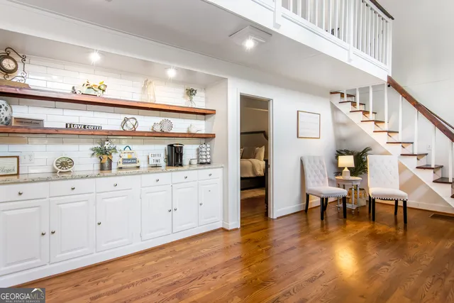 a living room with furniture and wooden floor