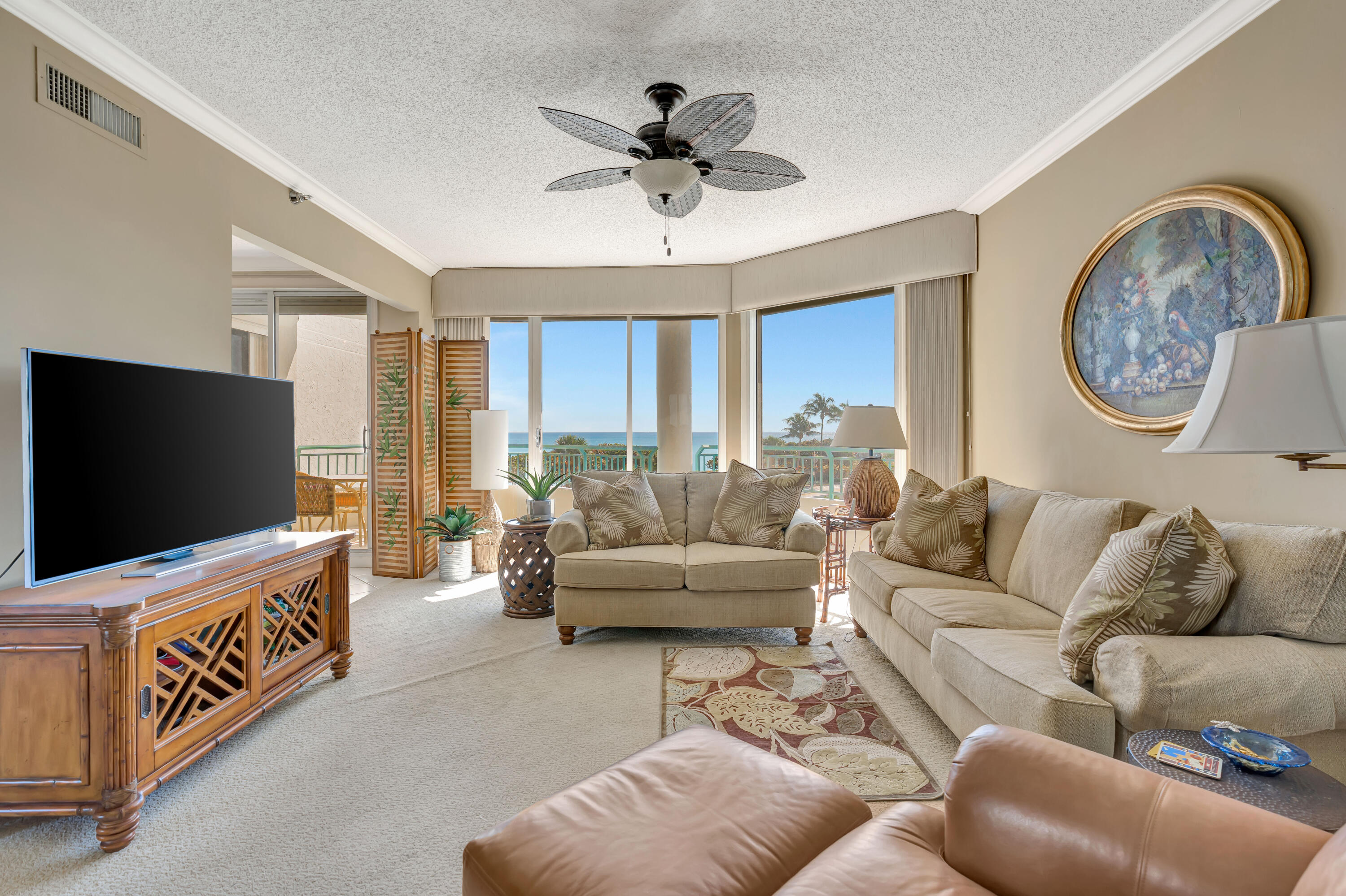 2000 Florida A1A, Unit N302 Jupiter, FL 33477 - Photo 15 of 65 a living room with furniture and a flat screen tv