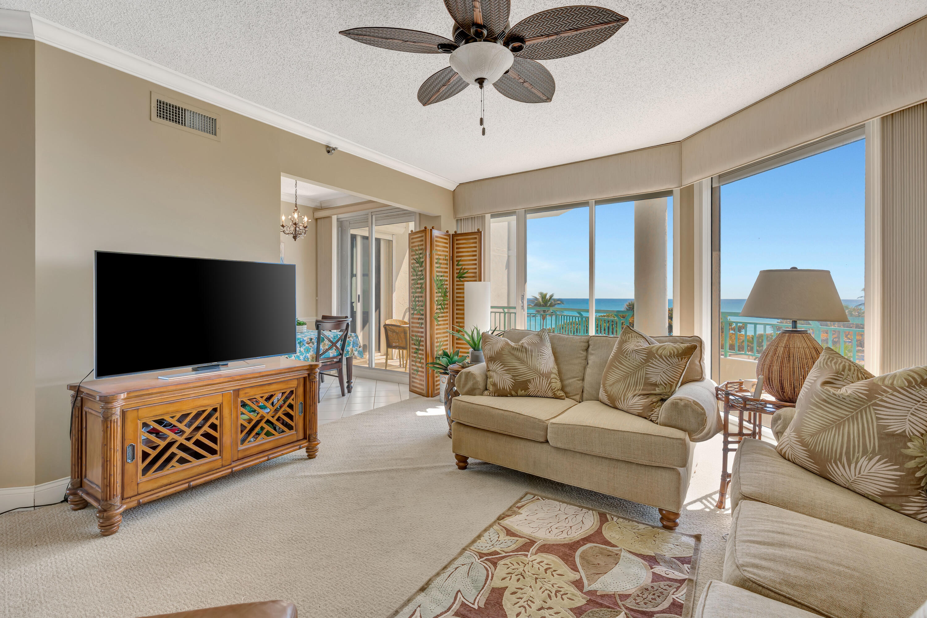 2000 Florida A1A, Unit N302 Jupiter, FL 33477 - Photo 16 of 65 a living room with furniture and a flat screen tv