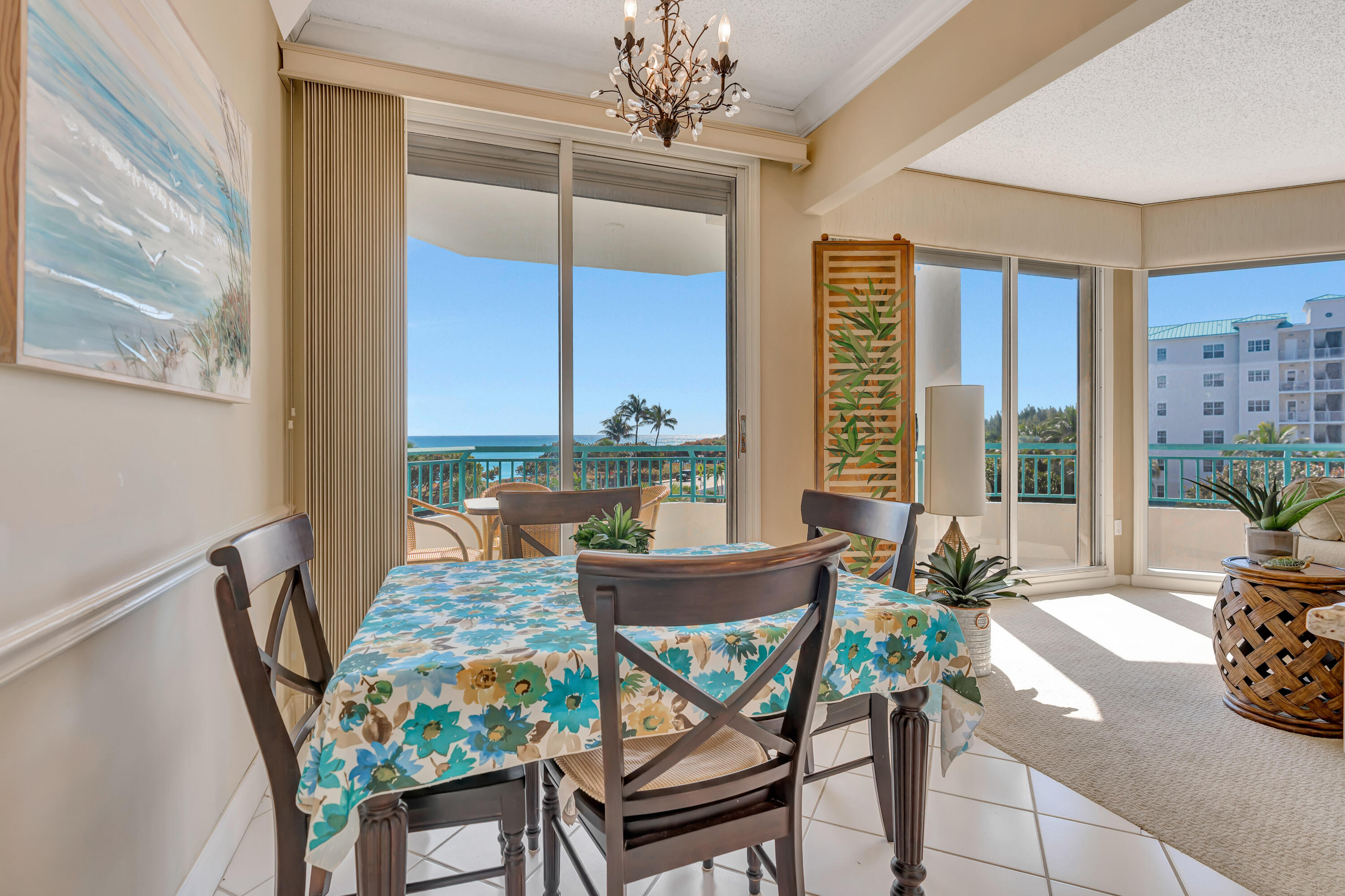2000 Florida A1A, Unit N302 Jupiter, FL 33477 - Photo 24 of 65 a dining room with furniture a chandelier and wooden floor