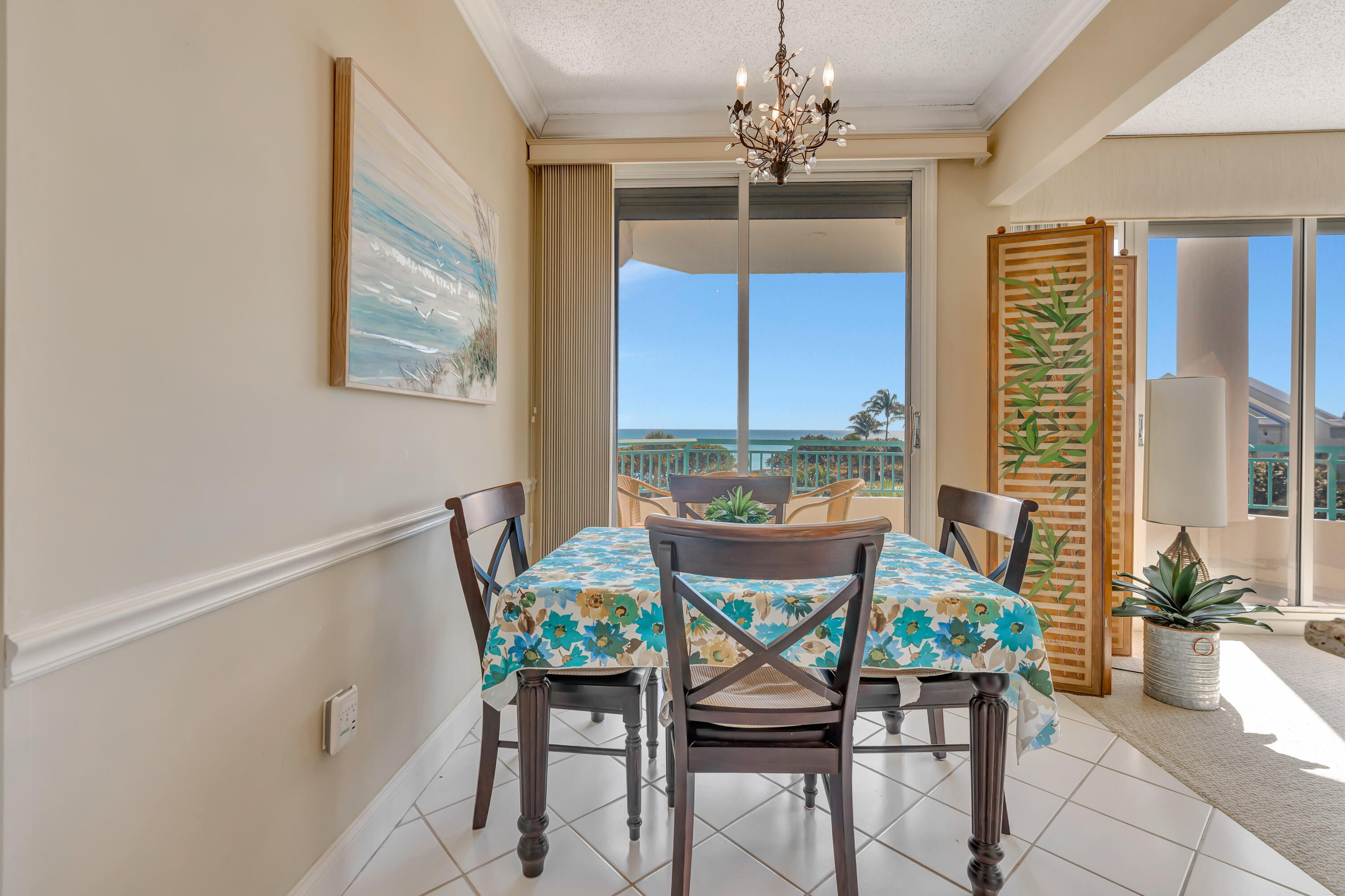 2000 Florida A1A, Unit N302 Jupiter, FL 33477 - Photo 25 of 65 a dining room with furniture a chandelier and window