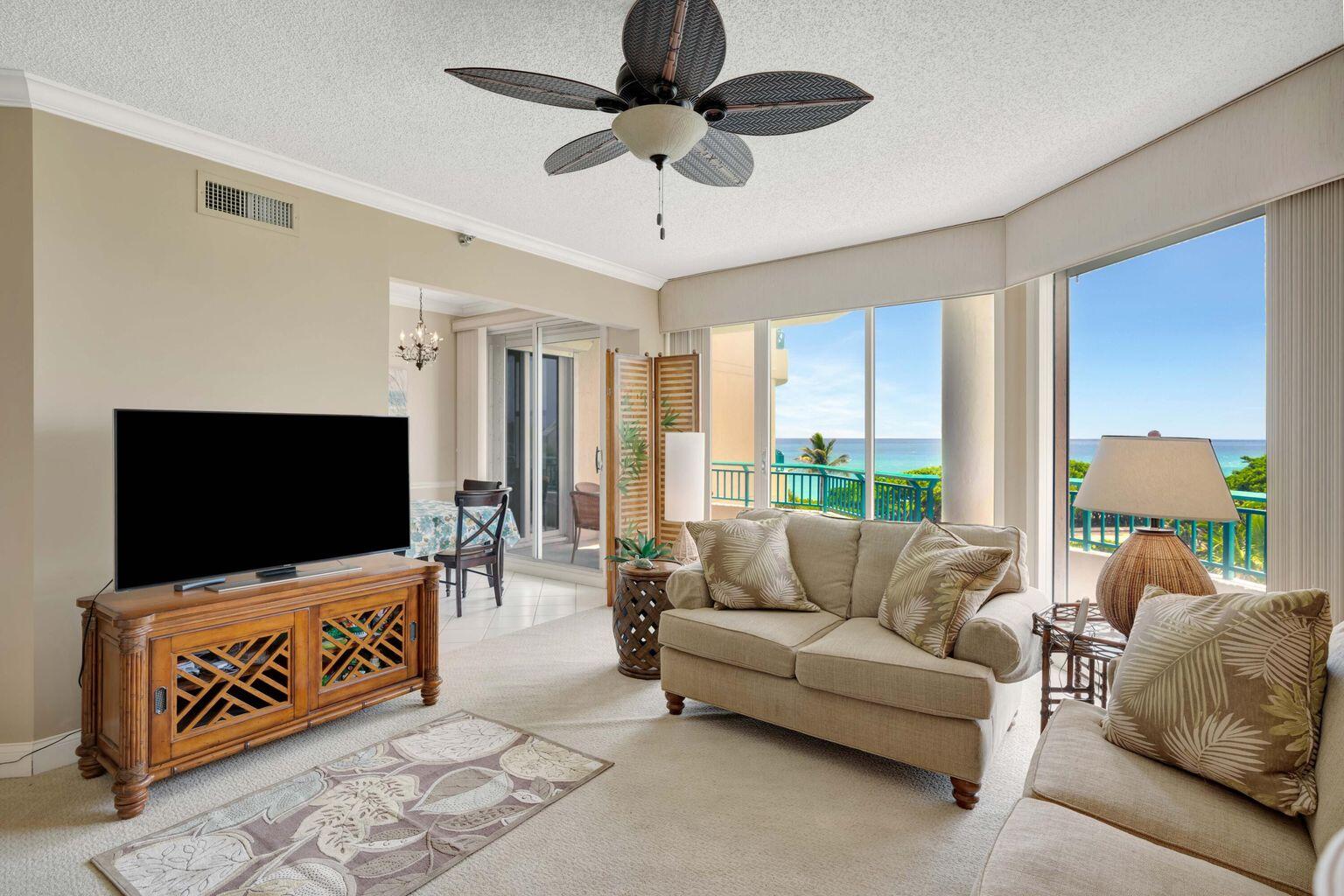 2000 Florida A1A, Unit N302 Jupiter, FL 33477 - Photo 30 of 65 a living room with furniture and a flat screen tv