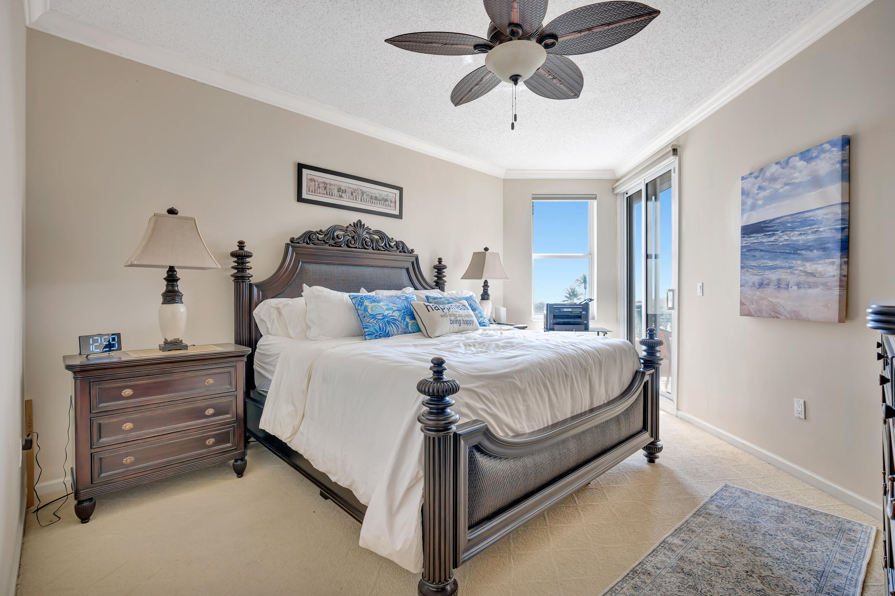 2000 Florida A1A, Unit N302 Jupiter, FL 33477 - Photo 36 of 65 a bedroom with a bed and ceiling fan
