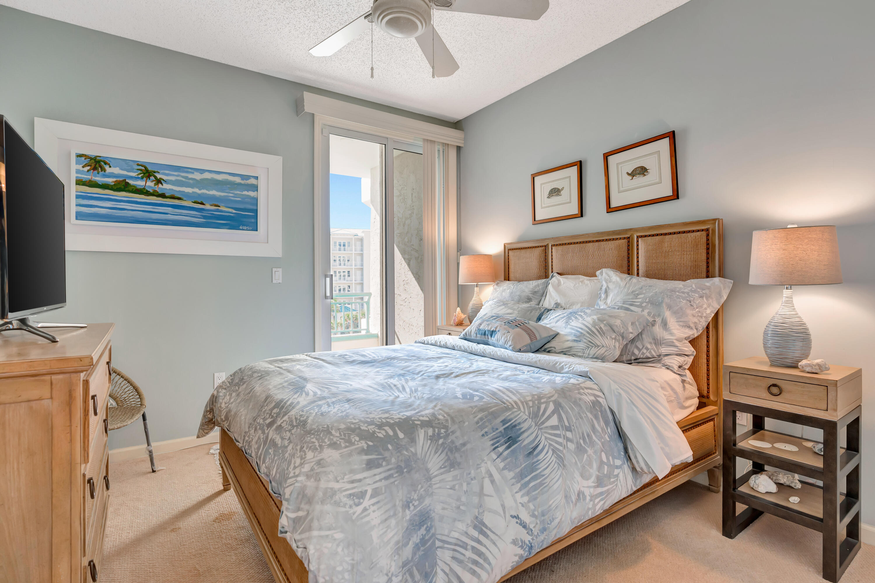 2000 Florida A1A, Unit N302 Jupiter, FL 33477 - Photo 42 of 65 a bedroom with a bed and a flat tv screen on dresser