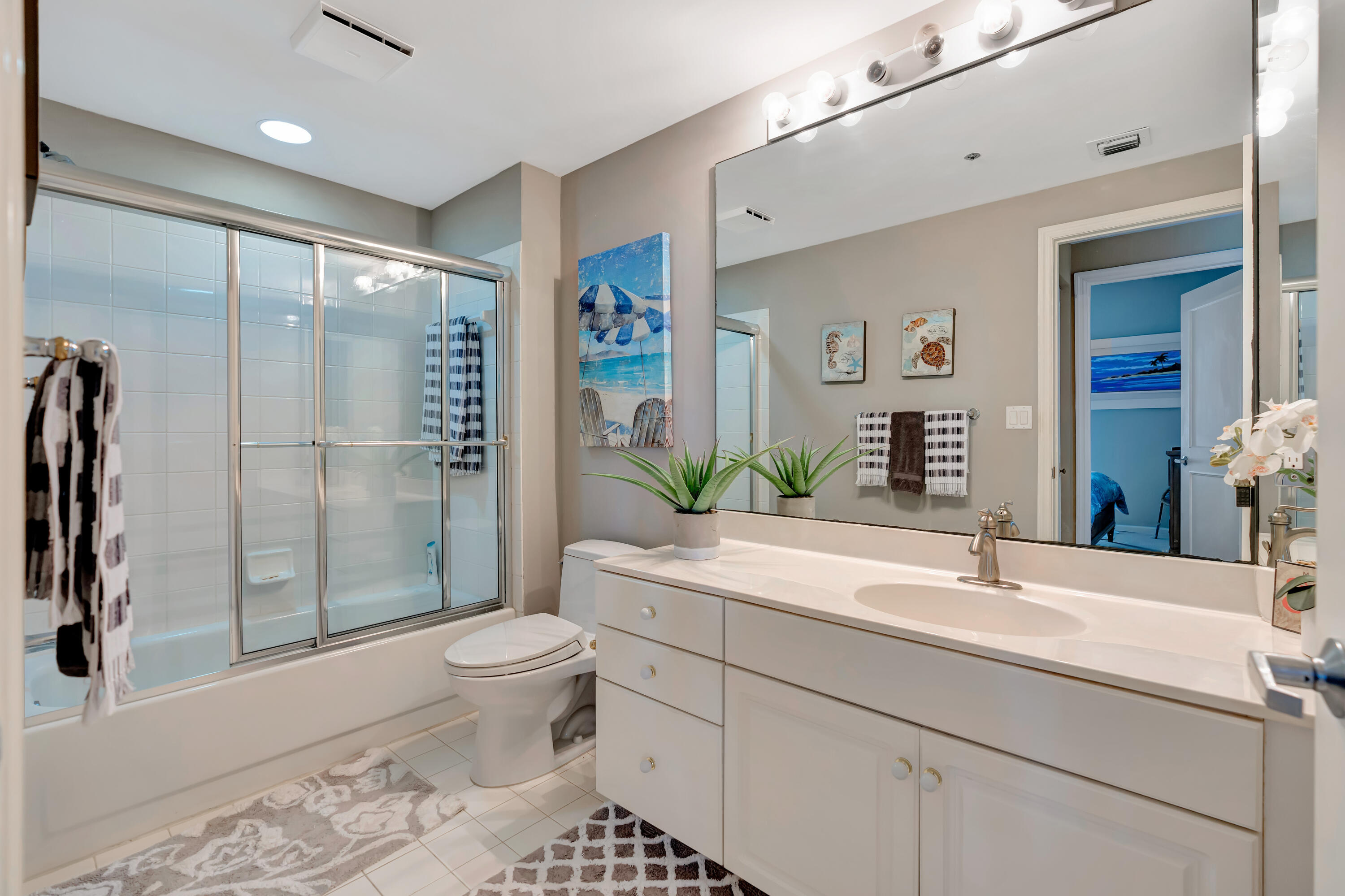 2000 Florida A1A, Unit N302 Jupiter, FL 33477 - Photo 44 of 65 a bathroom with a sink toilet and shower