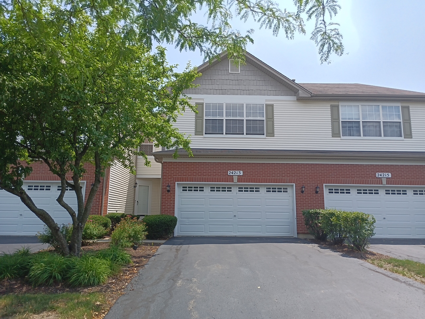 24213 Walnut Circle Plainfield, IL 60585 - Photo 1 of 15 a front view of a house with a yard and garage