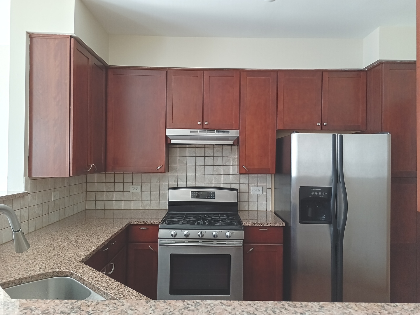 24213 Walnut Circle Plainfield, IL 60585 - Photo 2 of 15 a kitchen with a stove top oven and refrigerator