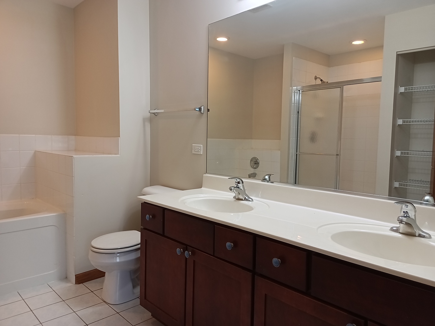 24213 Walnut Circle Plainfield, IL 60585 - Photo 8 of 15 a bathroom with a sink a toilet a light fixture and a mirror