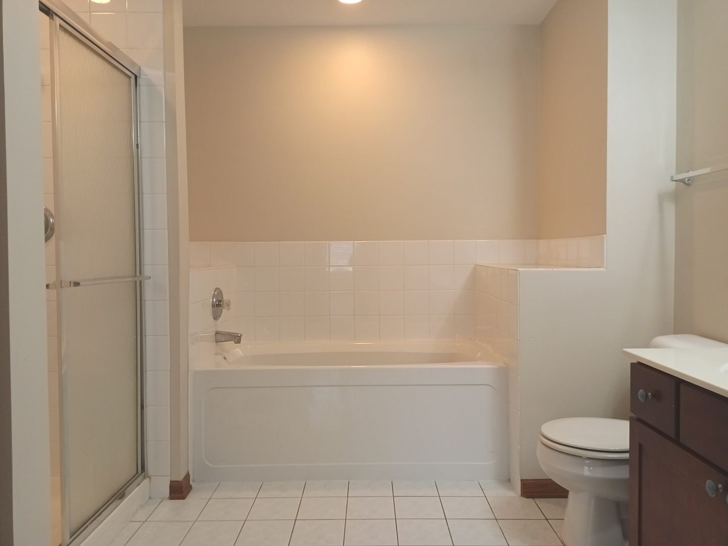 24213 Walnut Circle Plainfield, IL 60585 - Photo 9 of 15 a bathroom with a white toilet and tub