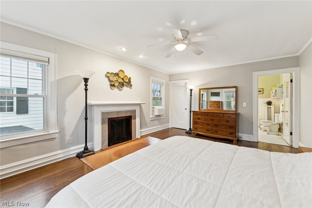 2925 East Overlook Road Cleveland Heights, OH 44118 - Photo 20 of 48 This room features hardwood floors, a fireplace with a stone surround, and windows providing natural light