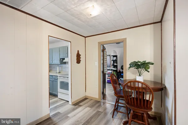 a dining room with furniture and wooden floor