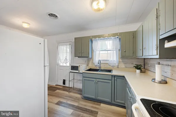 a kitchen with a sink a window and cabinets
