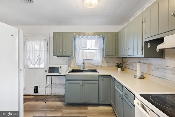 a kitchen with a sink cabinets and window