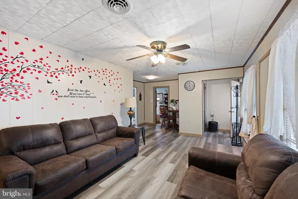 a living room with furniture and a chandelier