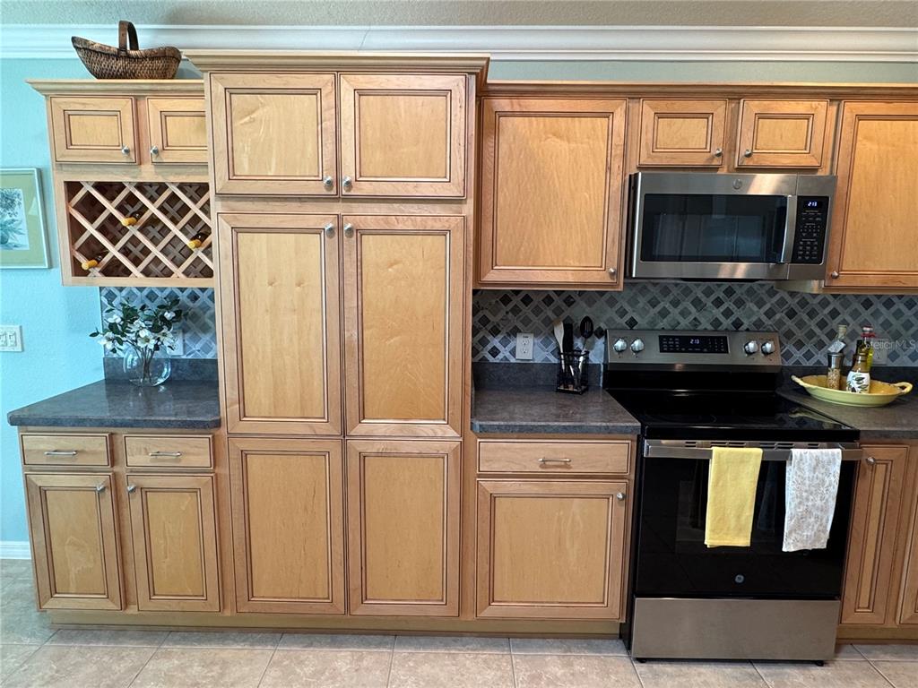3436 Countryside Path The Villages, FL 32163 - Photo 7 of 31 a kitchen with granite countertop a sink and a stove