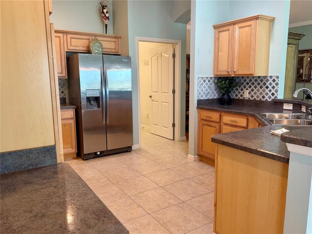 3436 Countryside Path The Villages, FL 32163 - Photo 8 of 31 a kitchen with stainless steel appliances granite countertop a refrigerator and a sink