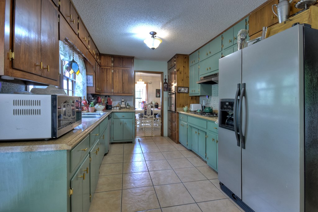 1359 Salem Road Mineral Bluff, GA 30559 - Photo 11 of 18 a kitchen with stainless steel appliances granite countertop a refrigerator a stove and a sink