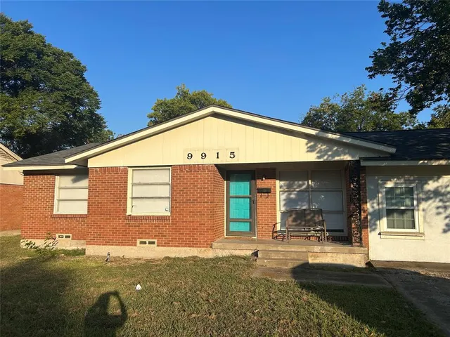 a backyard of a house with yard and outdoor seating