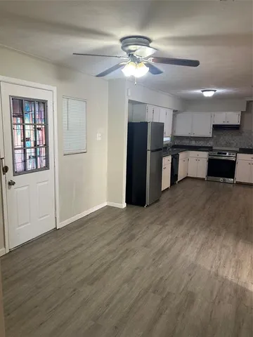 a view of kitchen with furniture and refrigerator