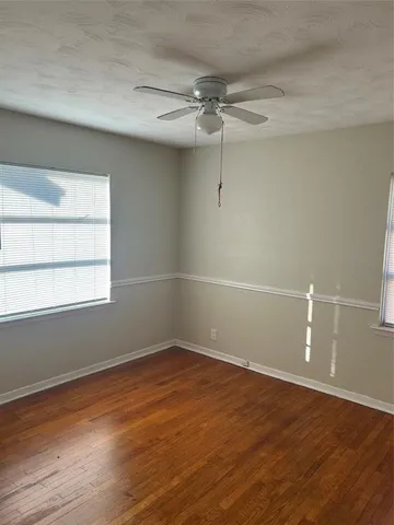 a view of a room with wooden floor and window