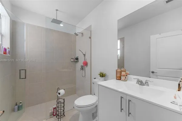 a spacious bedroom with a bed couch and a window