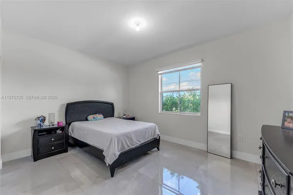 a bedroom with a bed and a lamp