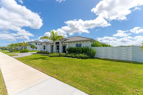 a view of a house with swimming pool and a yard