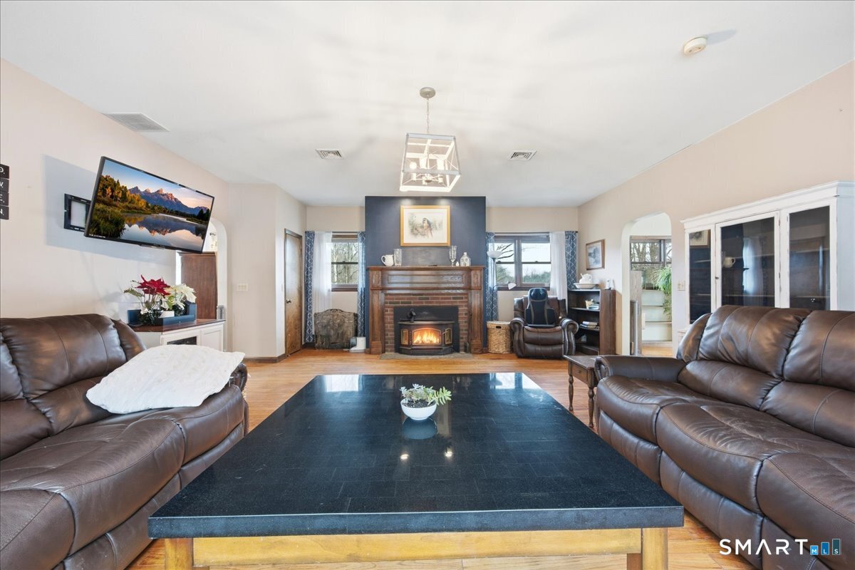 110 Butlertown Road Waterford, CT 06385 - Photo 11 of 35 a living room with furniture and a fireplace