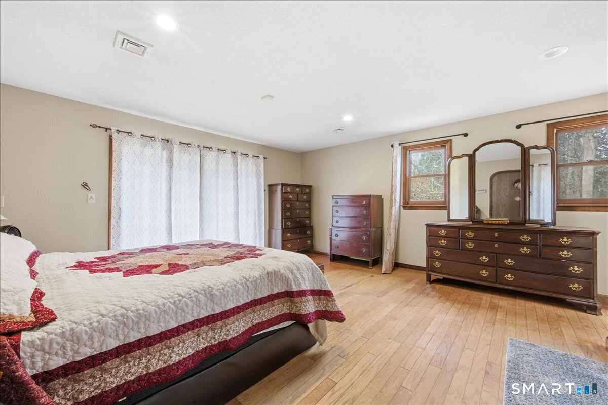 110 Butlertown Road Waterford, CT 06385 - Photo 15 of 35 a bedroom with a bed a closet and dresser