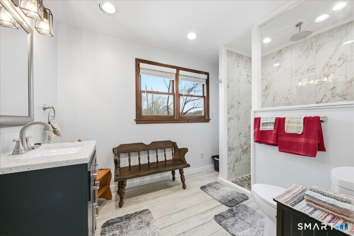 110 Butlertown Road Waterford, CT 06385 - Photo 16 of 35 a en suite bathroom with a toilet sink and mirror