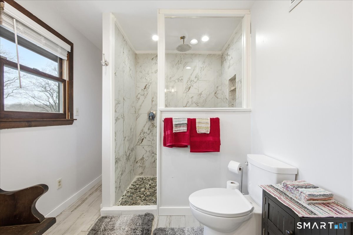 110 Butlertown Road Waterford, CT 06385 - Photo 17 of 35 a bathroom with a toilet and a shower