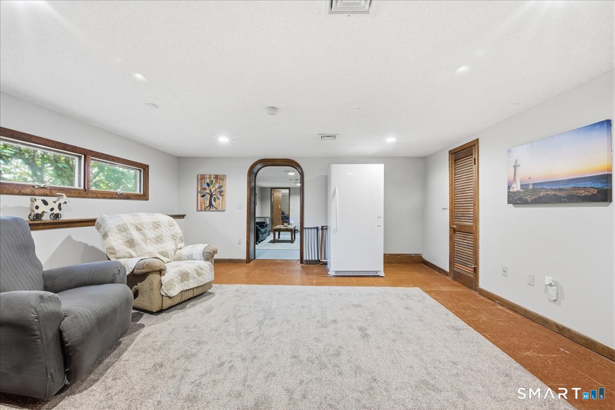 110 Butlertown Road Waterford, CT 06385 - Photo 20 of 35 a living room with furniture and a large window
