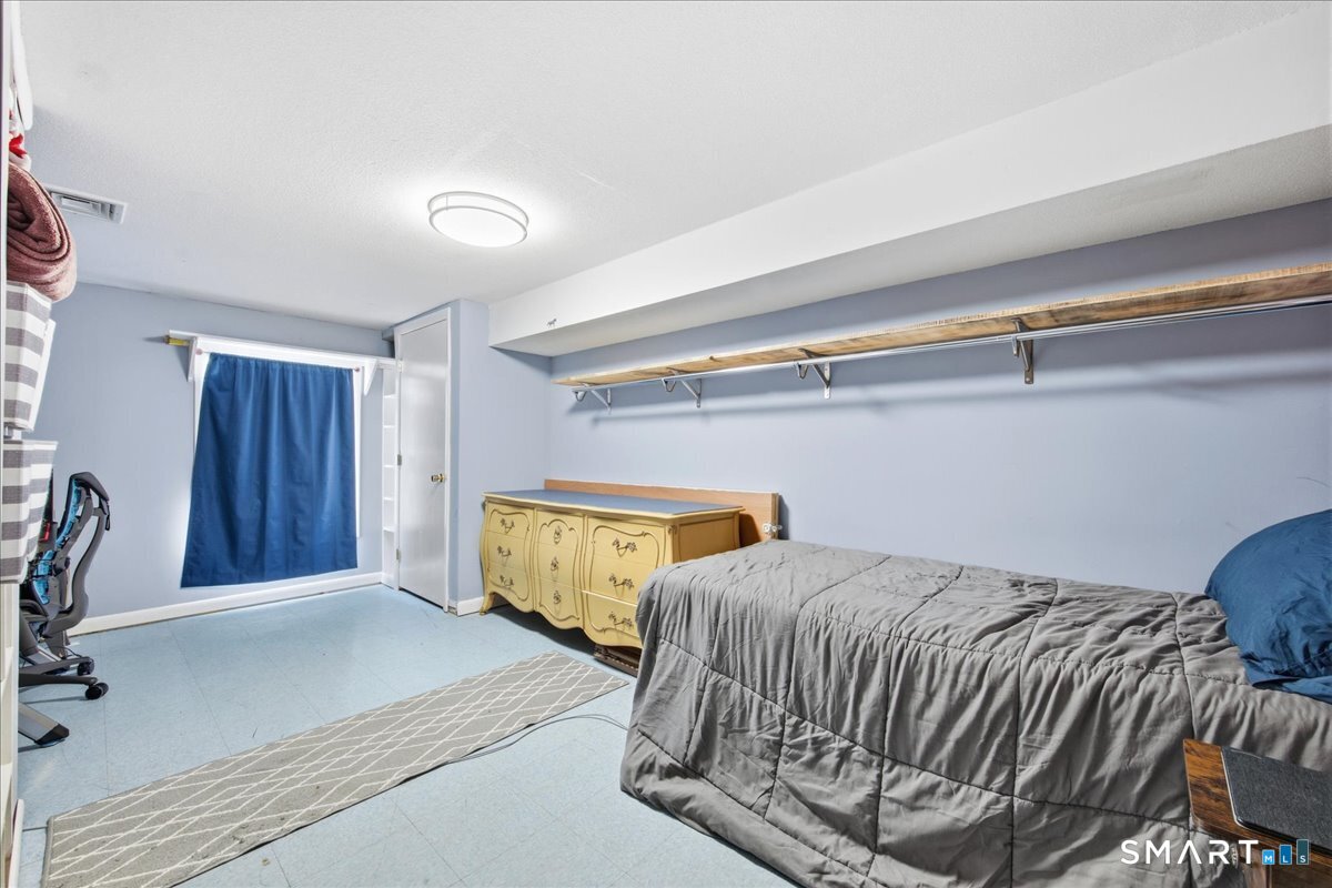 110 Butlertown Road Waterford, CT 06385 - Photo 26 of 35 a bedroom with a bed and a dresser