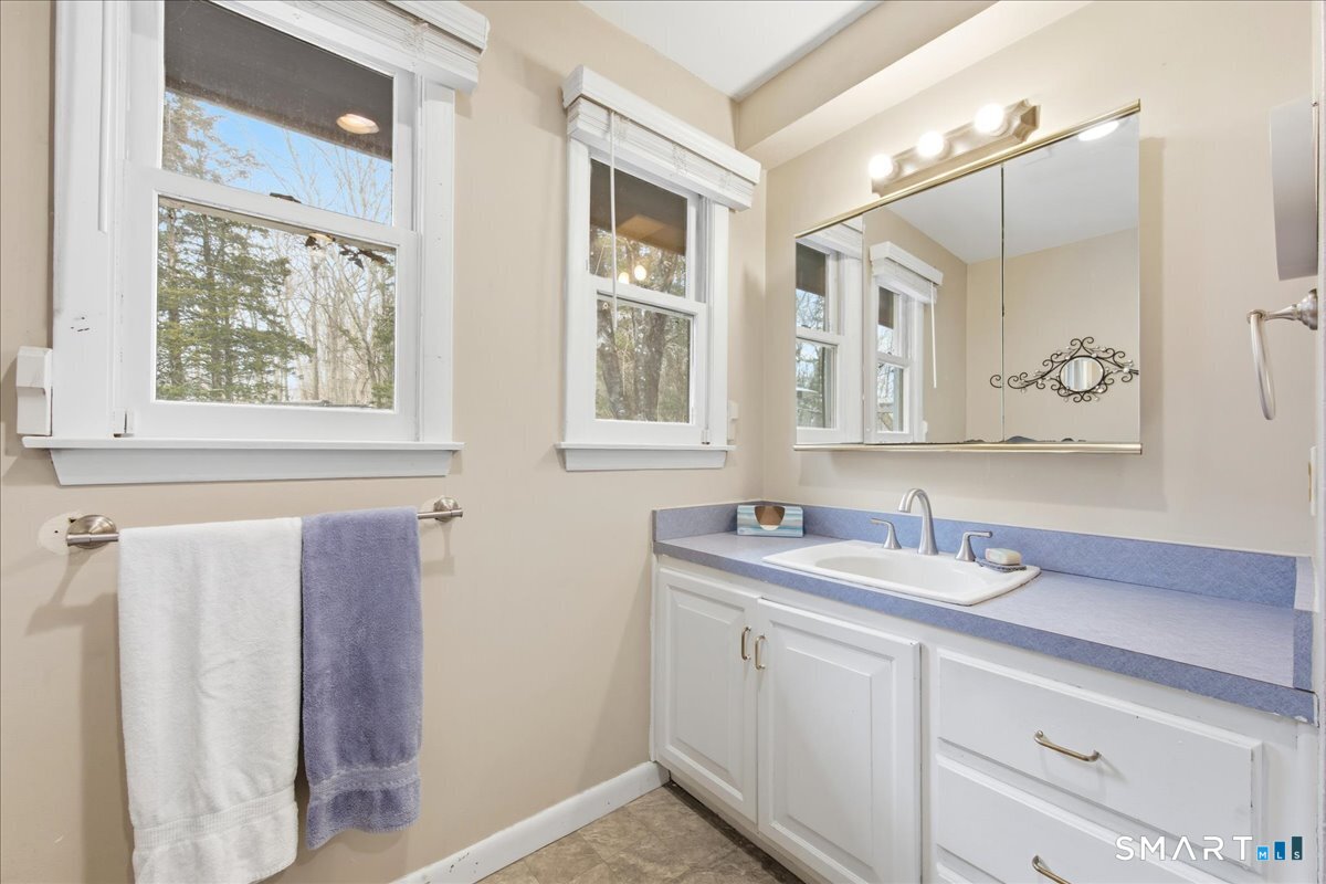 110 Butlertown Road Waterford, CT 06385 - Photo 28 of 35 a bathroom with a sink and a mirror
