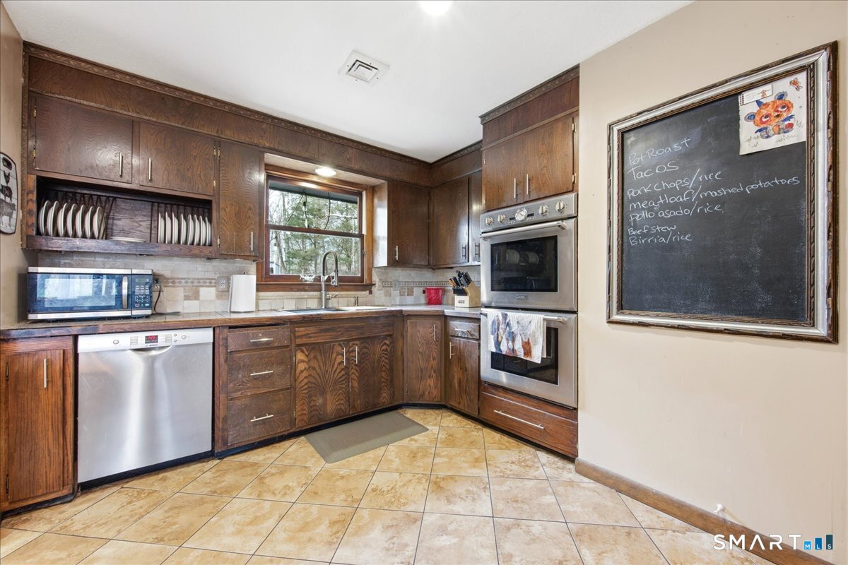 110 Butlertown Road Waterford, CT 06385 - Photo 3 of 35 a kitchen with stainless steel appliances granite countertop a refrigerator and a stove top oven