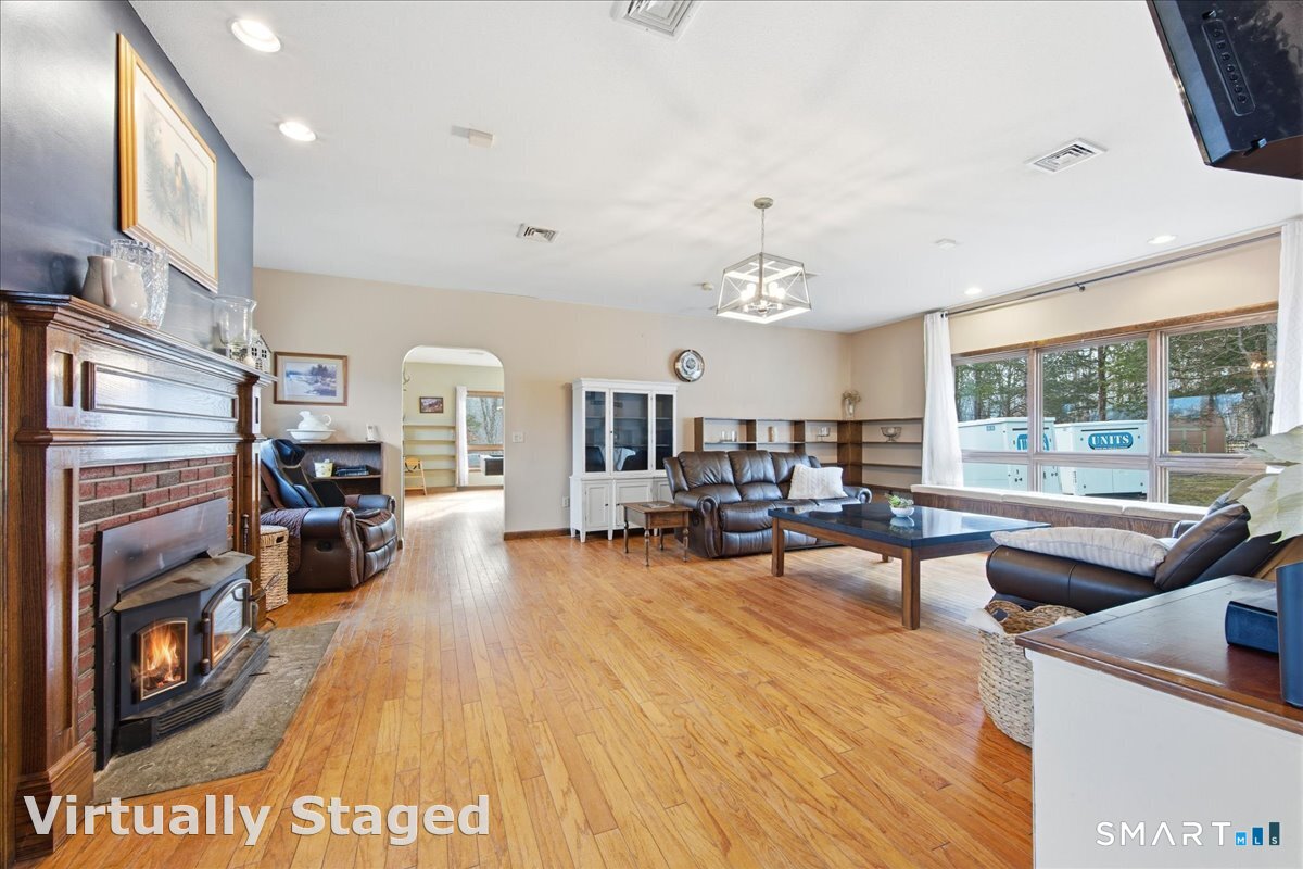 110 Butlertown Road Waterford, CT 06385 - Photo 8 of 35 a living room with furniture and a fireplace