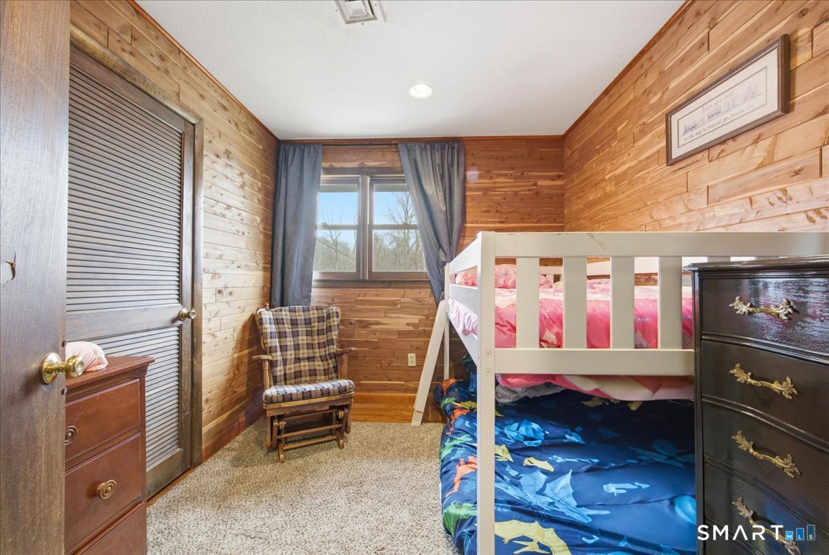 110 Butlertown Road Waterford, CT 06385 - Photo 10 of 35 a bedroom with a bed and wooden floor