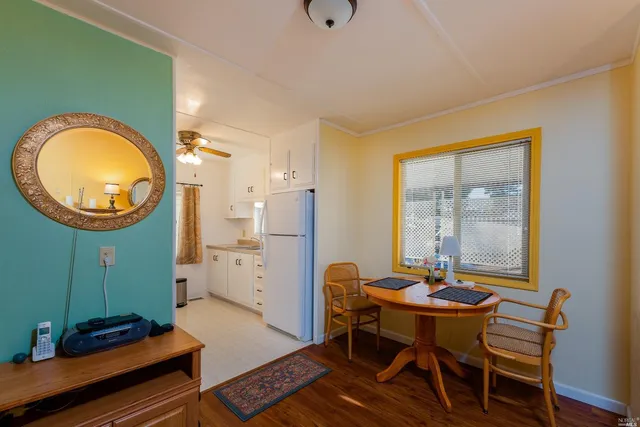 a view of a dining room with furniture and a window