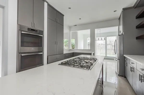 a kitchen with a refrigerator and a stove top oven