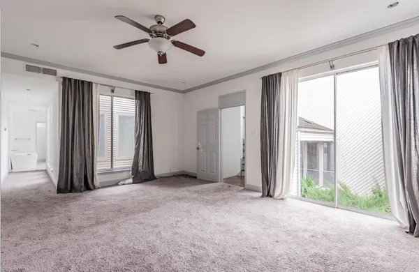 a view of a livingroom with a ceiling fan and window