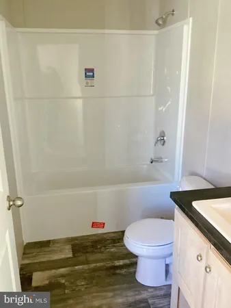 a bathroom with a sink a toilet and a shower