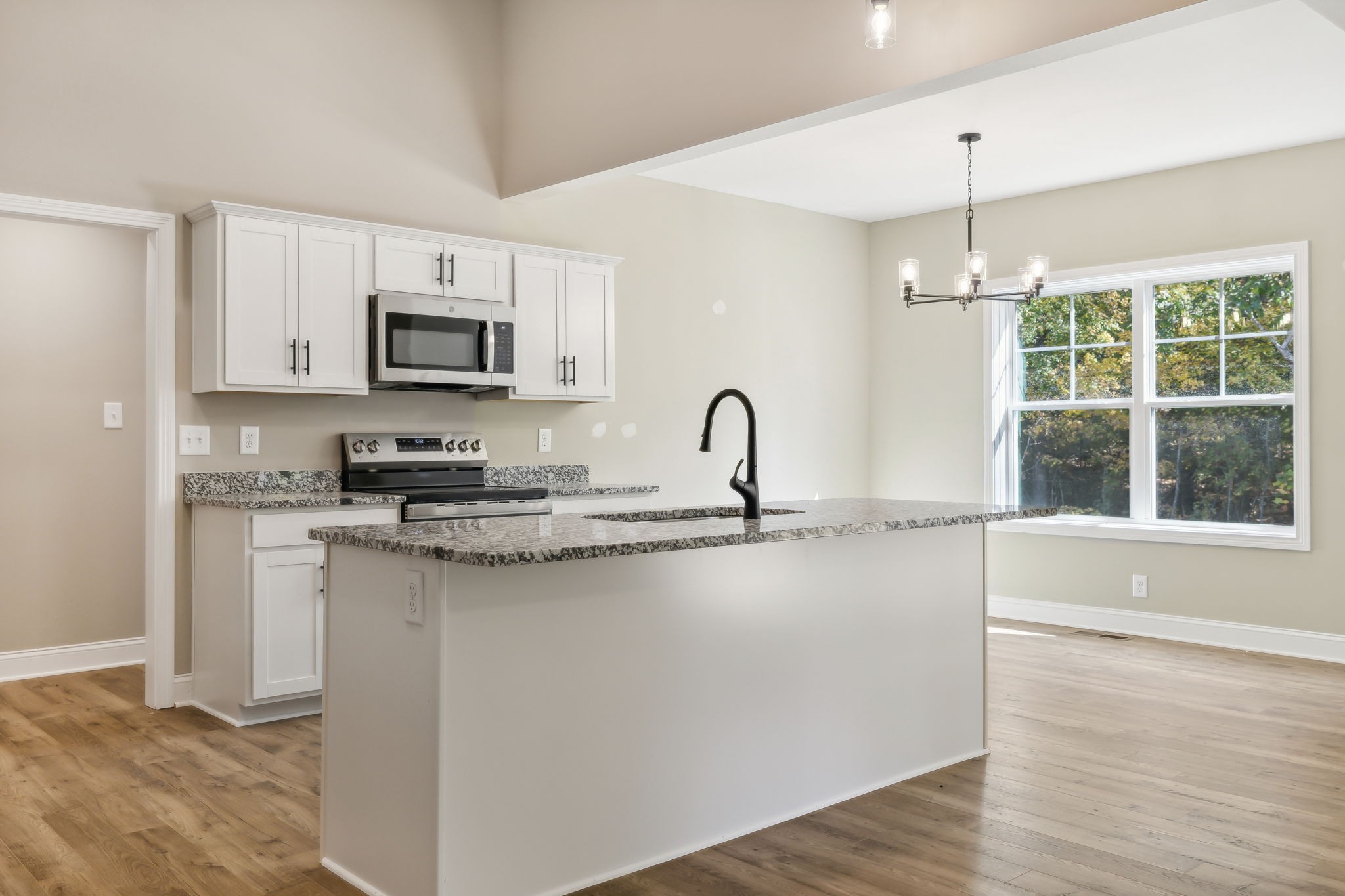 1228 Racker Drive Clarksville, TN 37043 - Photo 11 of 49 a kitchen with kitchen island granite countertop a sink cabinets and stainless steel appliances