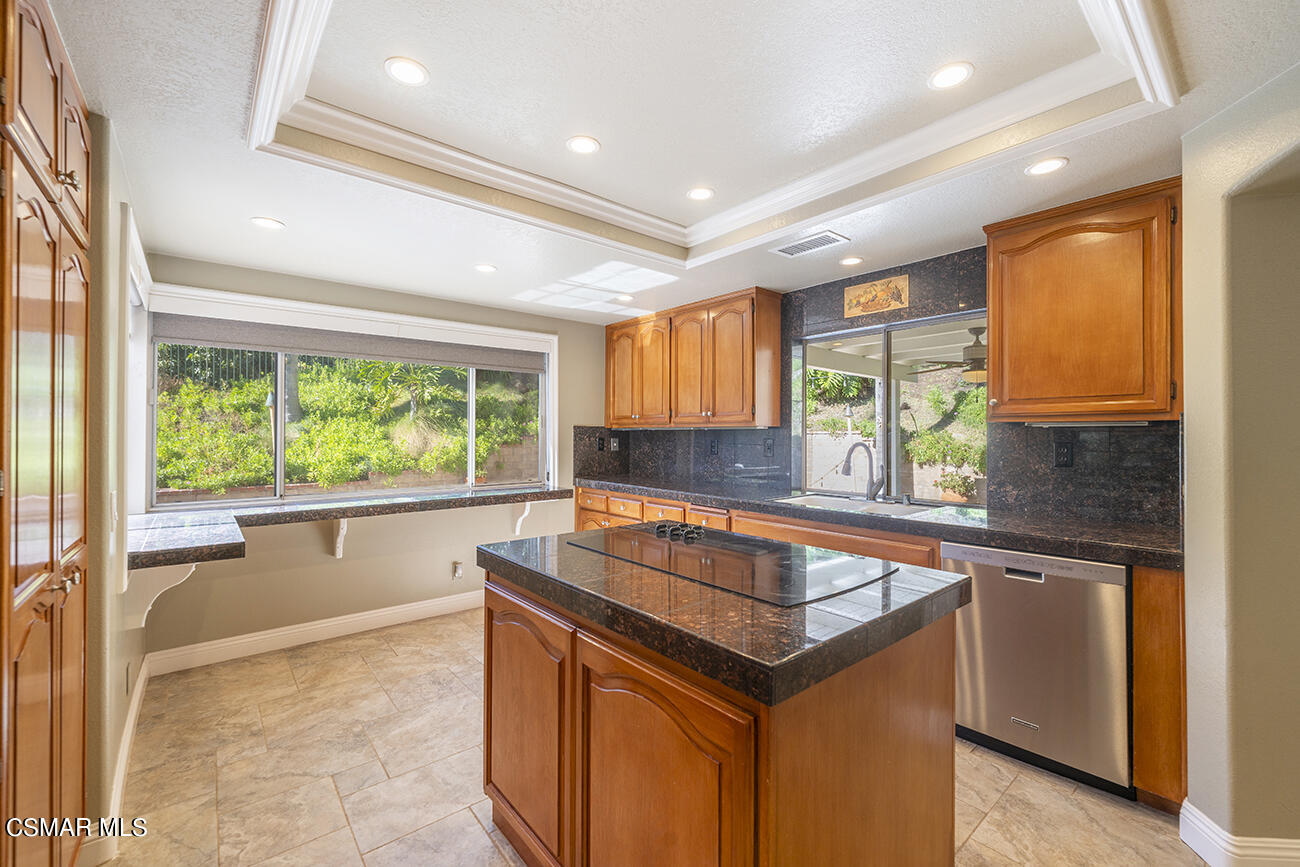 415 Fresh Meadows Road Simi Valley, CA 93065 - Photo 11 of 49 a kitchen that has a sink and a stove in it
