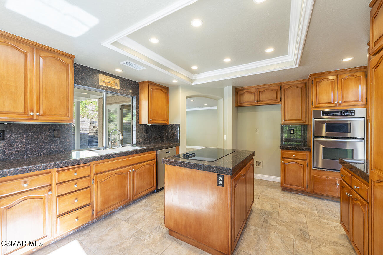 415 Fresh Meadows Road Simi Valley, CA 93065 - Photo 14 of 49 a kitchen with stainless steel appliances granite countertop a stove and a sink