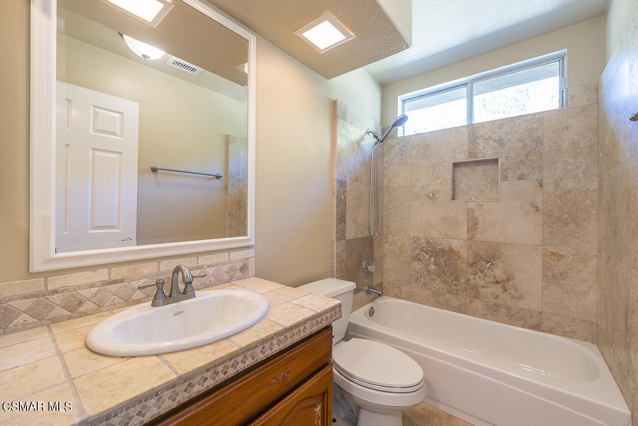415 Fresh Meadows Road Simi Valley, CA 93065 - Photo 27 of 49 a bathroom with a granite countertop sink toilet and shower