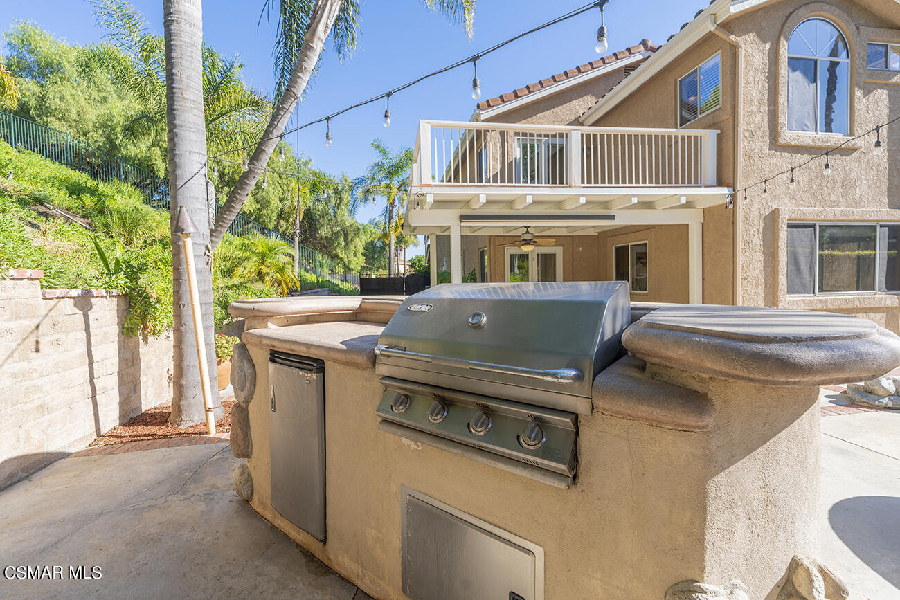 415 Fresh Meadows Road Simi Valley, CA 93065 - Photo 36 of 49 a view of a house with a sink and a table and chairs