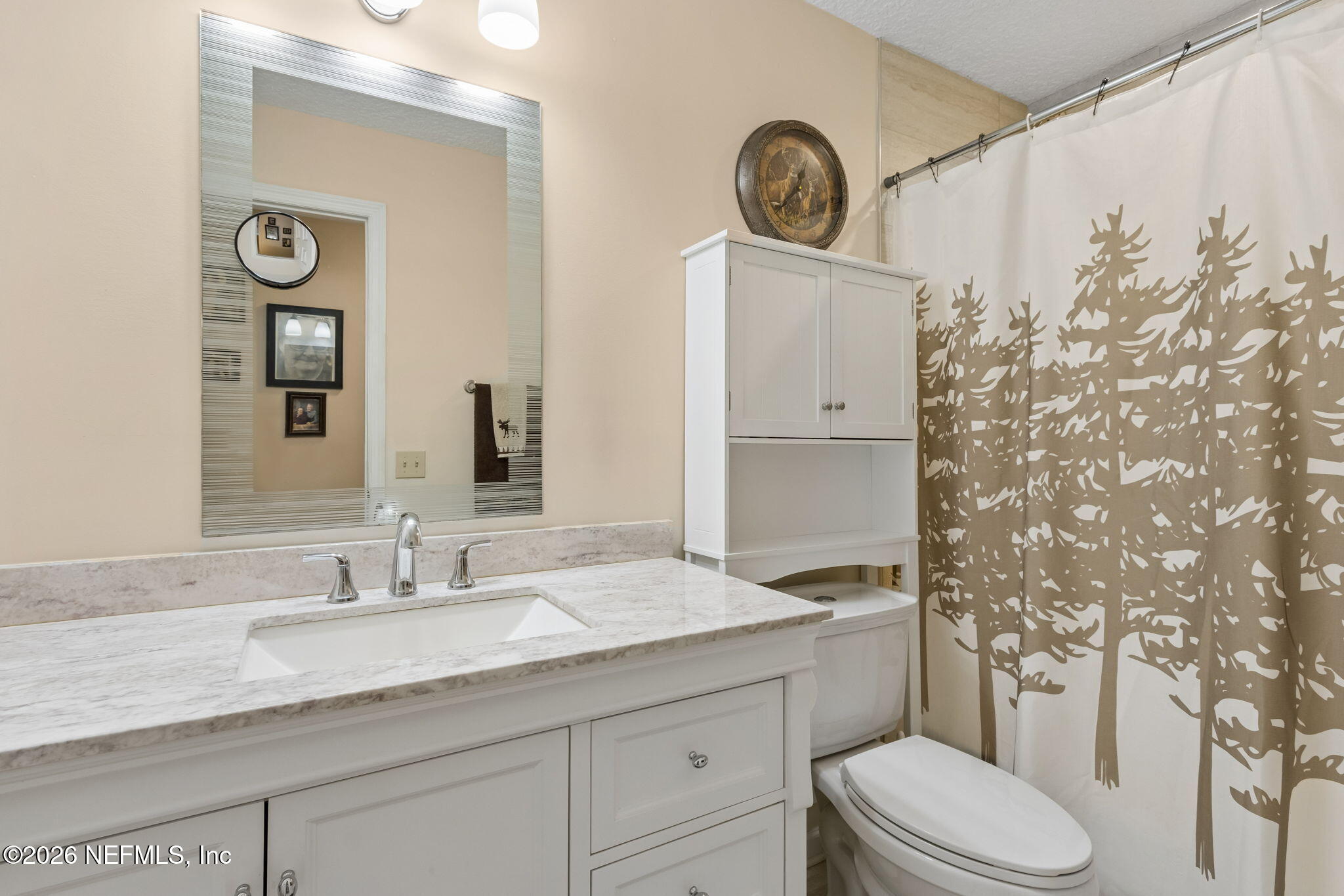 3194 Creighton Landing Road Fleming Island, FL 32003 - Photo 24 of 31 a bathroom with a granite countertop toilet sink and mirror